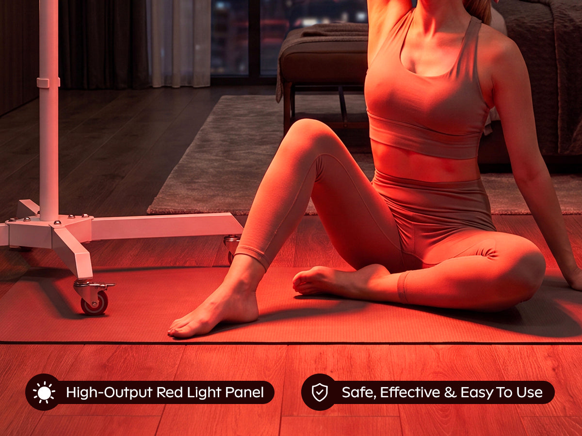 SOLRA portable red light panel on a wheeled stand beside a woman seated on a yoga mat at home